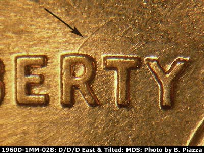 Die-stage B marker on 1960D•1MM•028 showing Curved die scratch from top of R in LIBERTY.