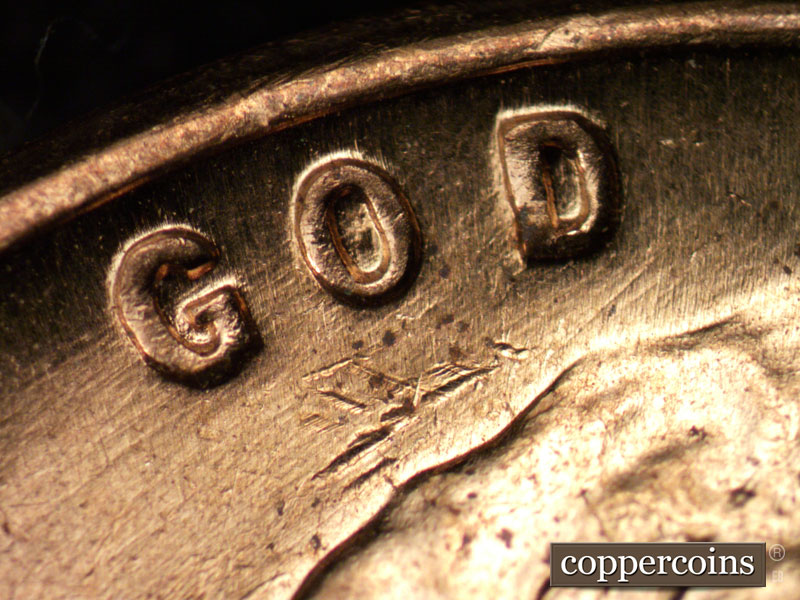 Die-stage B marker on 1960D•1MM•029 showing WSW die scratches through GOD.