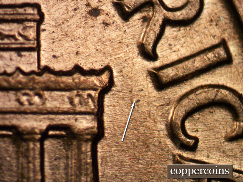 Die-stage B marker on 1960D•1MM•029 showing ESE die scratch from right cornice to C in AMERICA>.