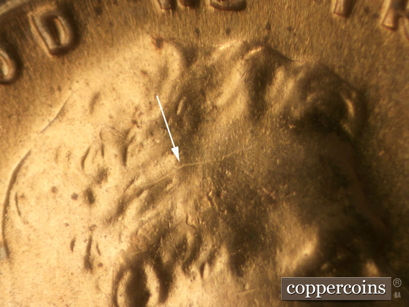 Die-stage C marker on 1960D•1MM•031 showing Die crack in hair.