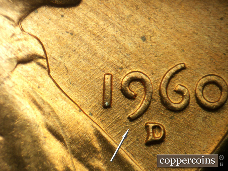 Die-stage A marker on 1960D•1MM•032 showing SE die scratches through date, Curved die scratch under 9 in date.
