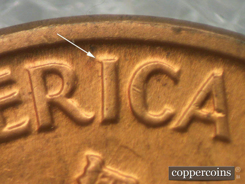 Die-stage B marker on 1960D•1MM•032 showing Die chip upper left of I in AMERICA. , ,.