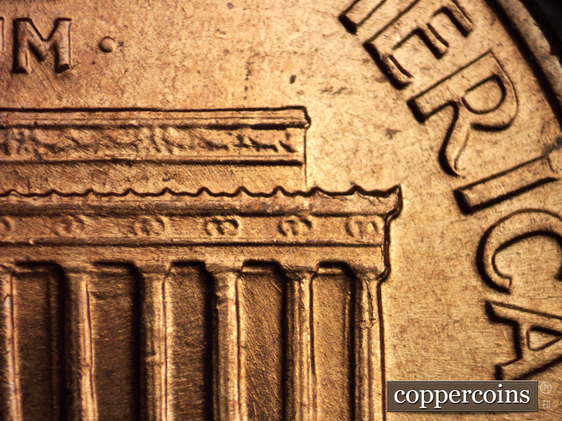 Die-stage C marker on 1960D•1MM•032 showing Die chipping on right cornice.
