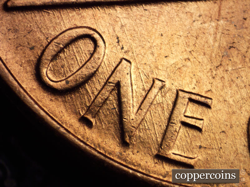 Die-stage C marker on 1960D•1MM•032 showing SSE die scratches from left base through ONE.