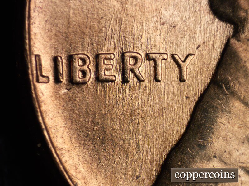 Die-stage B marker on 1960D•1MM•033 showing N/S die scratches through ERTY in LIBERTY.