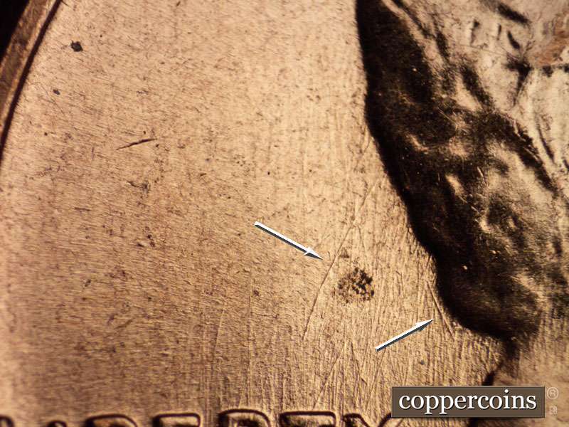 Die-stage C marker on 1960D•1MM•033 showing SW die scratch from back of head toward LIBERTY.