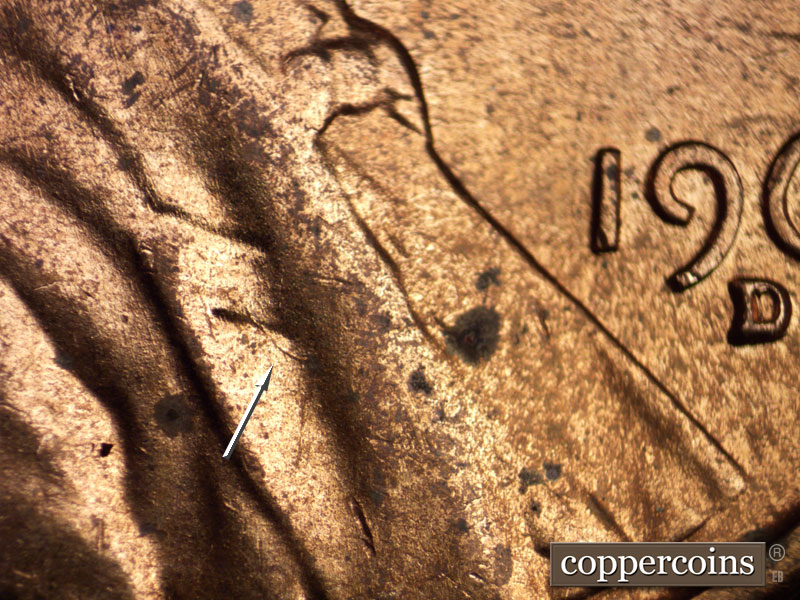 Die-stage B marker on 1960D•1MM•035 showing A small die gouge on the lapel.