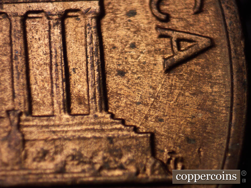 Die-stage B marker on 1960D•1MM•035 showing Die scratch NE from right base to last A in AMERICA.