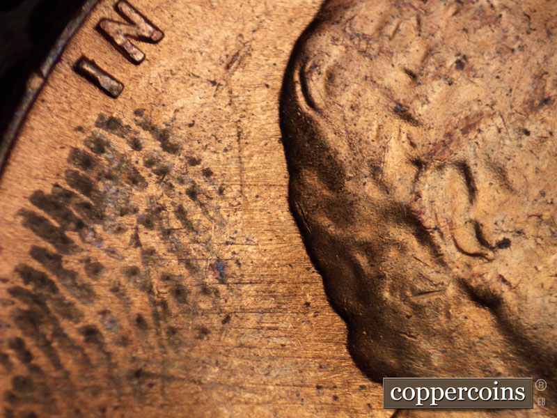 Die-stage B marker on 1960D•1MM•036 showing E/W die scratches across upper half of obverse.