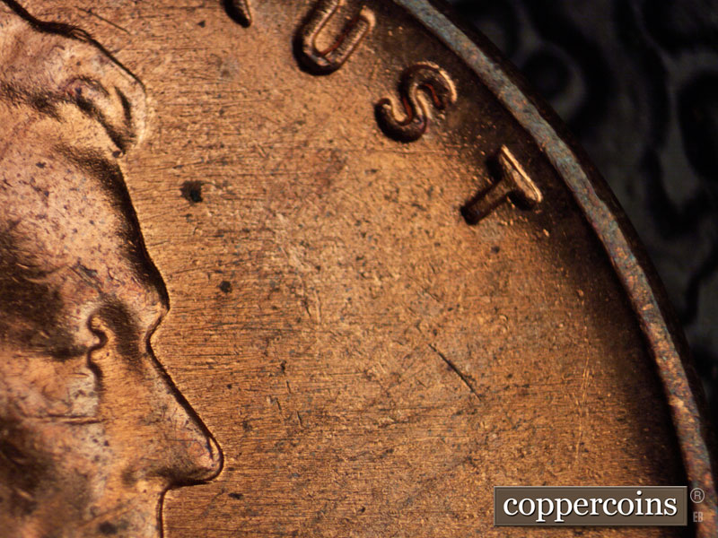 Die-stage B marker on 1960D•1MM•036 showing E/W die scratches across upper half of obverse.