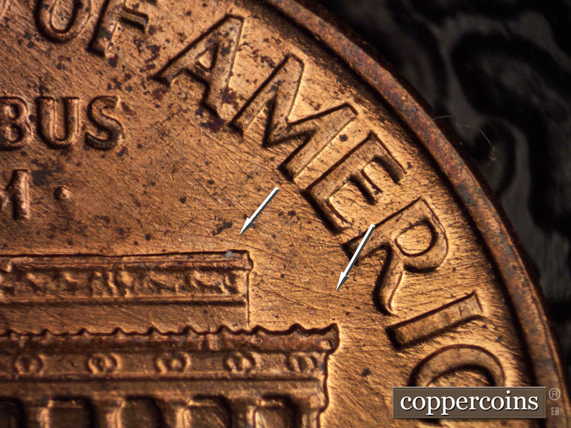 Die-stage B marker on 1960D•1MM•036 showing Curved die scratches from right roof toward R in AMERICA.