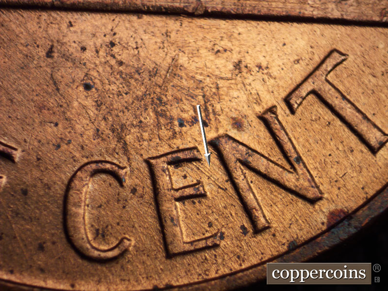 Die-stage B marker on 1960D•1MM•036 showing SE die scratch from top of E to N in CENT.