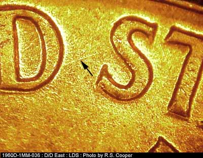 Die-stage C marker on 1960D•1MM•036 showing A die scratch between the D of UNITED and the first S of STATES.