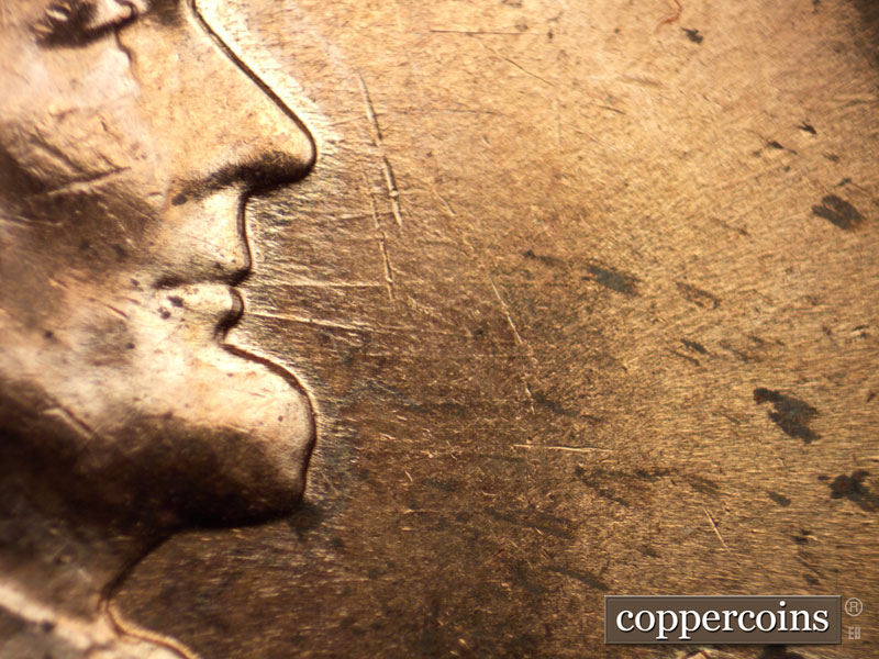 Die-stage B marker on 1960D•1MM•037 showing E/W die scratches from front of mouth.