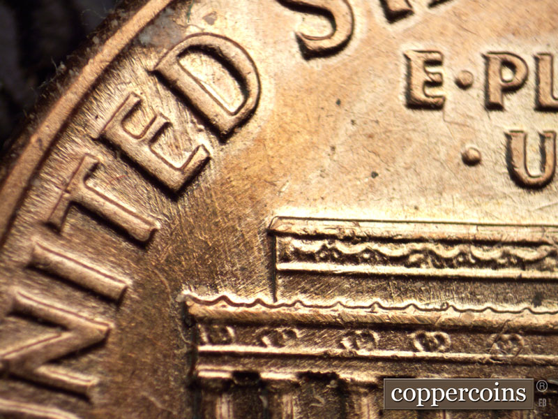 Die-stage B marker on 1960D•1MM•037 showing NNW die scratches from left cornice through TED in UNITED.