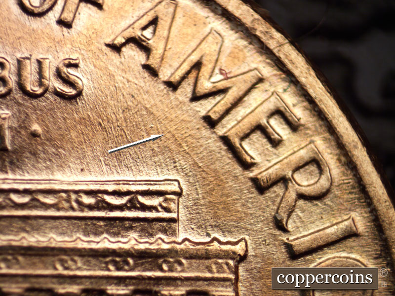 Die-stage B marker on 1960D•1MM•037 showing Heave SE die scratch under AME in AMERICA.