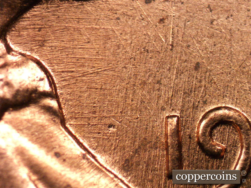 Die-stage C marker on 1960D•1MM•037 showing Crossing die scratches in front of date.