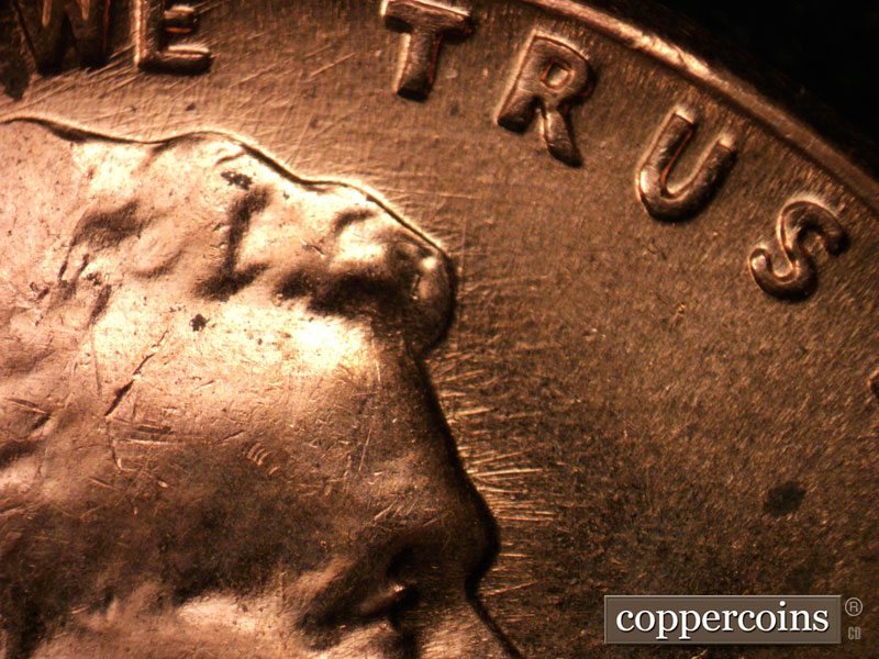 Die-stage C marker on 1960D•1MM•037 showing Short E/W die scratches from forehead.