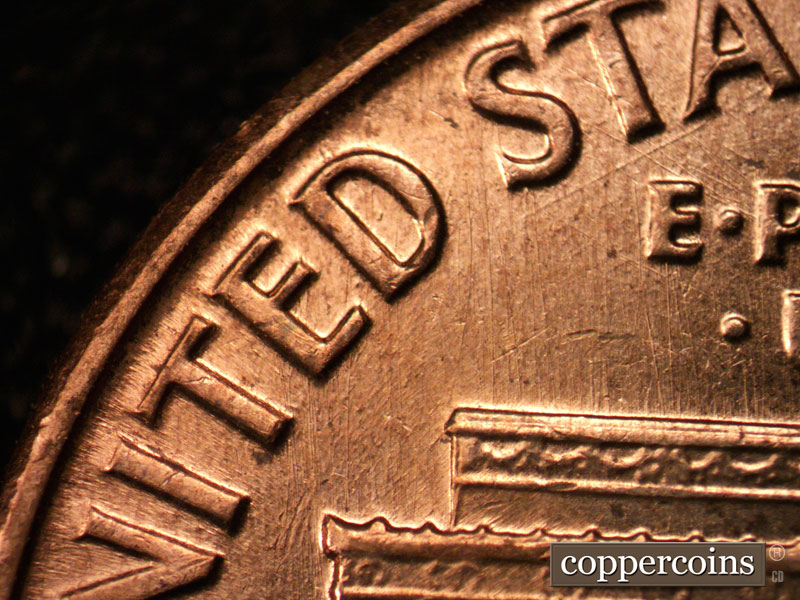 Die-stage C marker on 1960D•1MM•037 showing A strong die scratch below the STA of STATES.