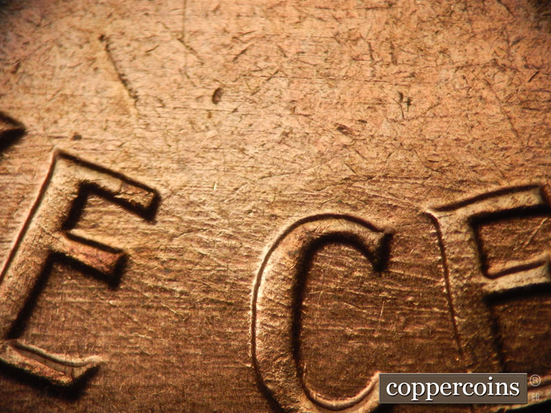 Die-stage B marker on 1960D•1MM•038 showing Multidirectional die scratches through CENT.