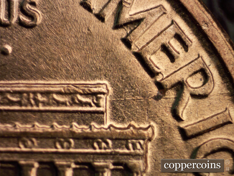 Die-stage B marker on 1960D•1MM•039 showing E/W die gouge from right roof through R in AMERICA.