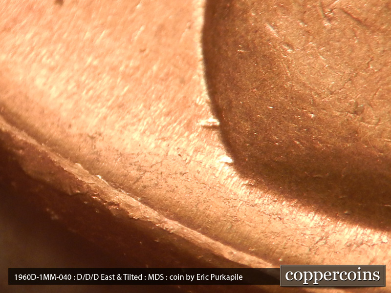 Die-stage B marker on 1960D•1MM•040 showing Two die gouges can be found at the base of the shoulder.