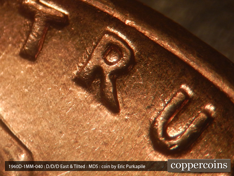 Die-stage B marker on 1960D•1MM•040 showing Die dot near R in TRUST.