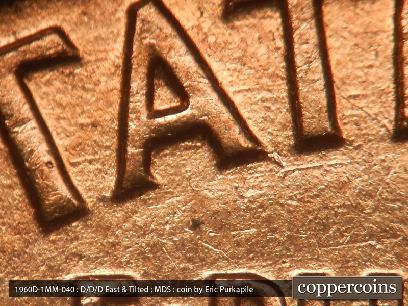 Die-stage B marker on 1960D•1MM•040 showing A die chip at the base of the right leg of the A in States.