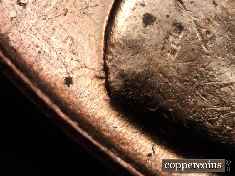 Die-stage C marker on 1960D•1MM•040 showing Two worn die gouges can be found at the base of the shoulder.
