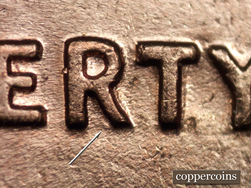 Die-stage C marker on 1960D•1MM•040 showing Worn die gouge in bottom of R in LIBERTY.