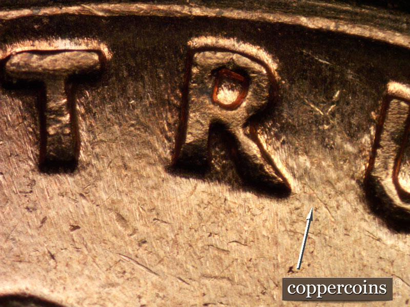 Die-stage C marker on 1960D•1MM•040 showing Very worn die dot between RU in TRUST.