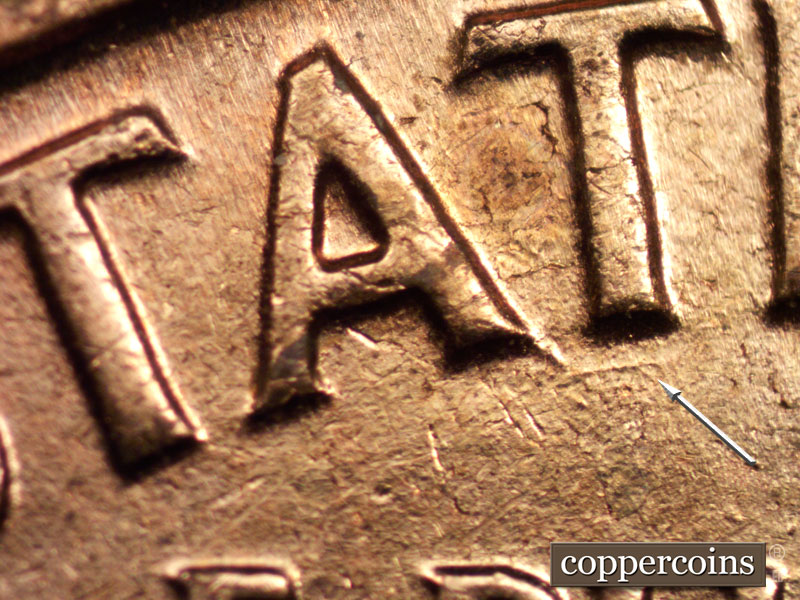 Die-stage C marker on 1960D•1MM•040 showing A die chip at the base of the right leg of the A in STATES. Die gouge under AT in STATES.