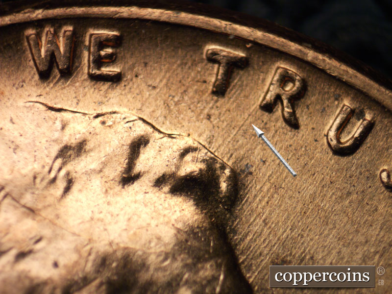 Die-stage B marker on 1960D•1MM•042 showing Die scratch from first leg of R in TRUST to hair.