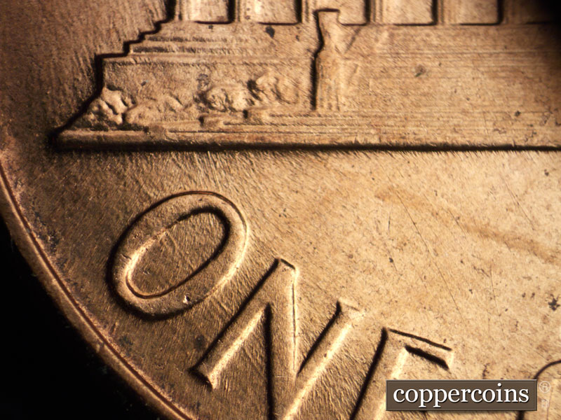 Die-stage B marker on 1960D•1MM•042 showing Concentric die scratches through ON in ONE.