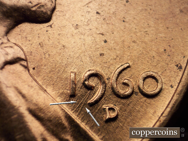 Die-stage C marker on 1960D•1MM•042 showing Two SW die scratches come from upper loop of 9 to lapel.