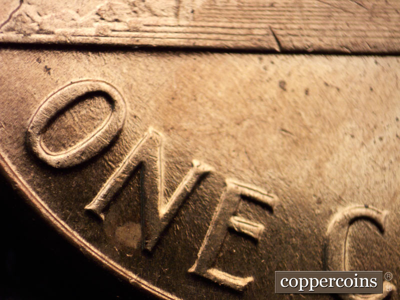 Die-stage C marker on 1960D•1MM•042 showing Concentric die scratches through ON in ONE are barely visible.
