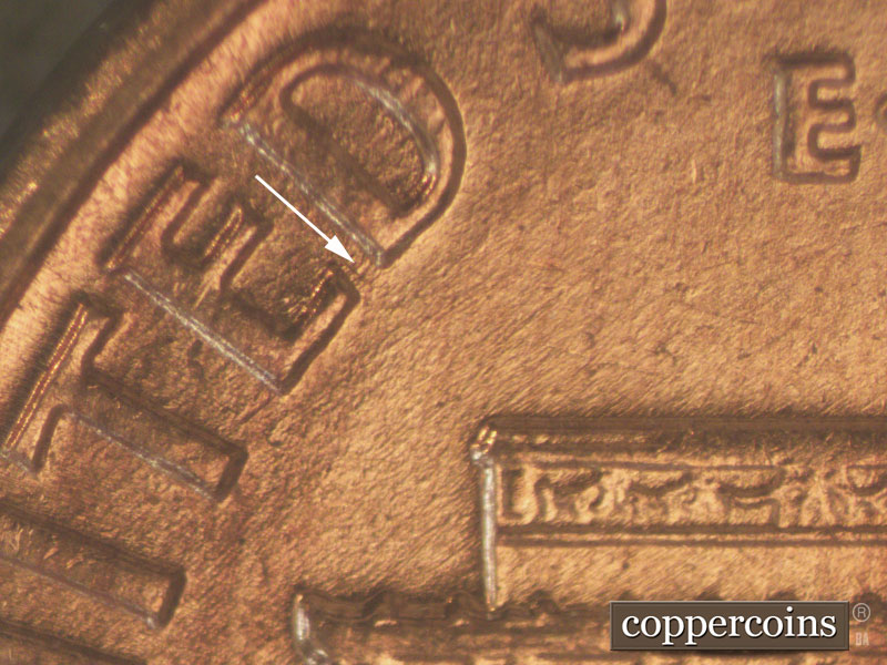 Die-stage B marker on 1960D•1MM•044 showing Small die crack connects lower ED of UNITED.