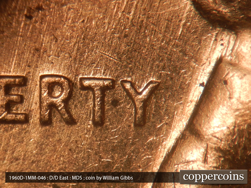 Die-stage B marker on 1960D•1MM•046 showing NNE die scratches through LIBERTY.