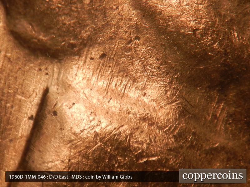 Die-stage B marker on 1960D•1MM•046 showing Die scratches on neck covering outline.