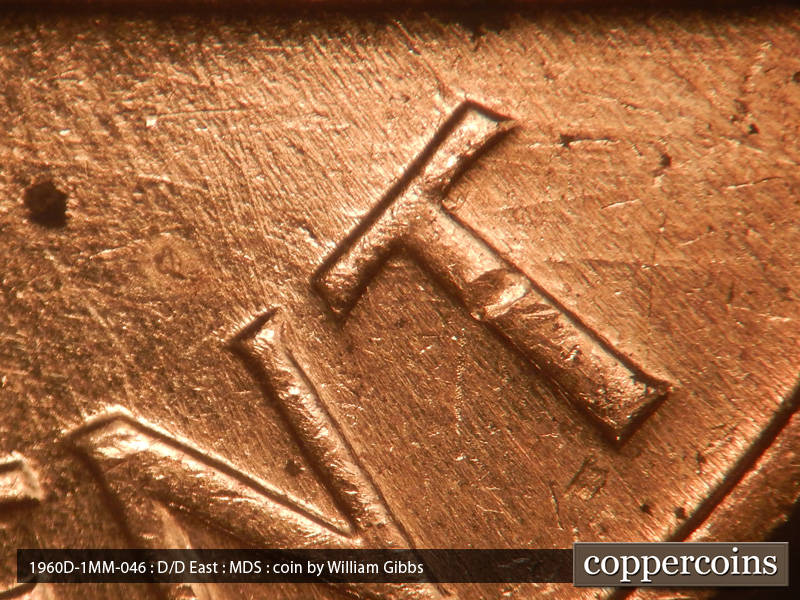 Die-stage B marker on 1960D•1MM•046 showing Die scratches north from the 2nd vertical bar of the N in CENT.