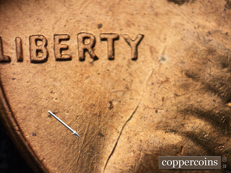 Die-stage C marker on 1960D•1MM•046 showing Die scratches come to form a V in field under LIBERTY.