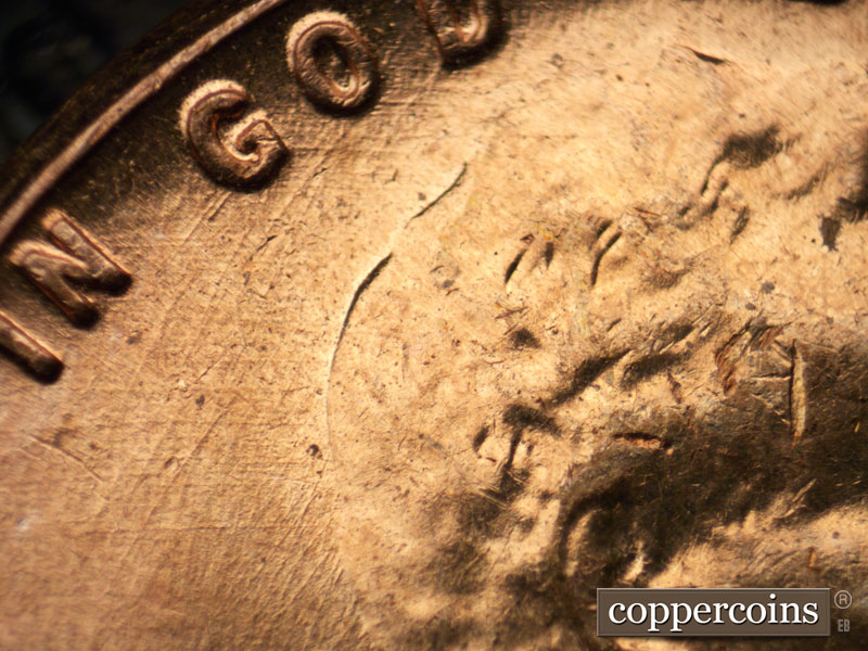 Die-stage C marker on 1960D•1MM•046 showing Crossing die scratches through GOD.