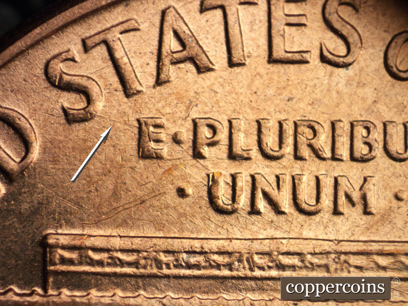 Die-stage C marker on 1960D•1MM•046 showing Heavy die scratch from lower first S in STATES through E PLURIBUS.
