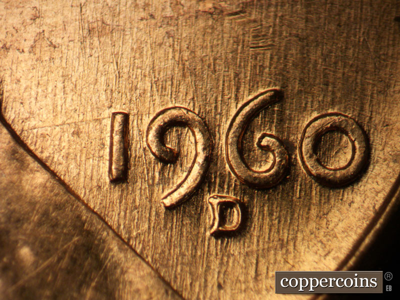 Die-stage A marker on 1960D•1MM•047 showing N/S die scratches through date.