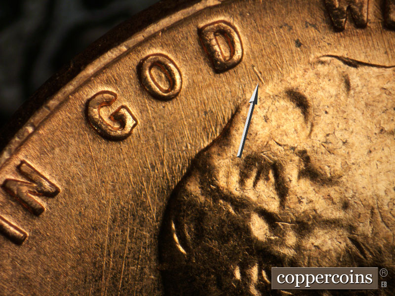 Die-stage A marker on 1960D•1MM•047 showing Short heavy NW die scratch from top of hair toward D in GOD.
