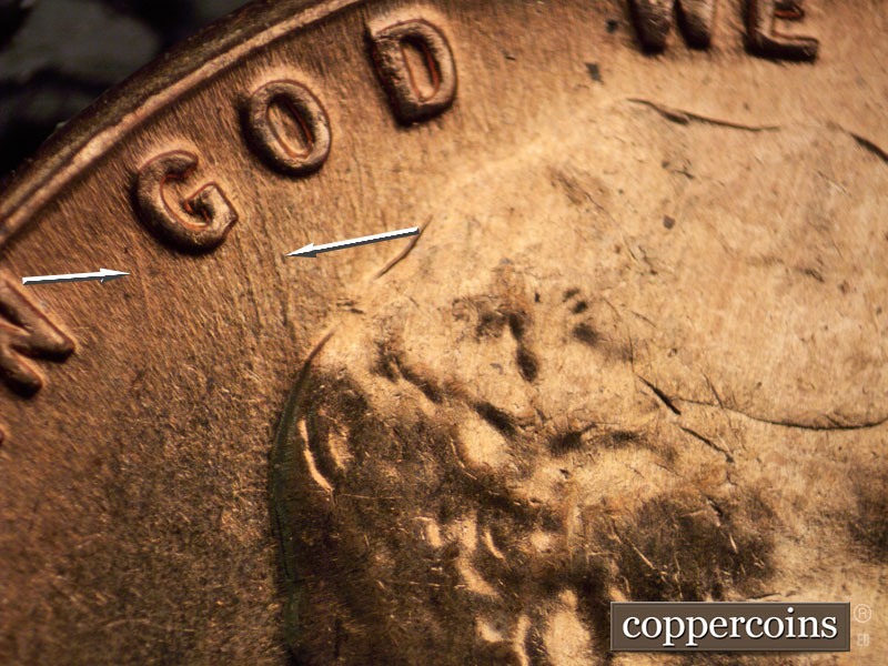 Die-stage C marker on 1960D•1MM•047 showing Worn die scratches run SSE from GOD.