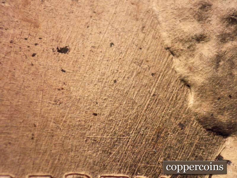 Die-stage A marker on 1960D•1MM•048 showing NNE die scratches in field above LIBERTY.