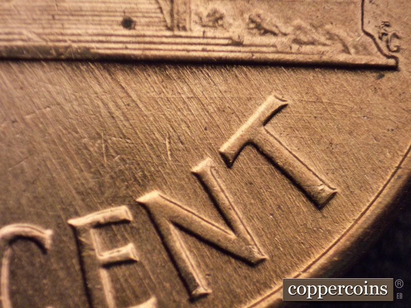 Die-stage A marker on 1960D•1MM•048 showing Crossing die scratches show above NT in CENT.