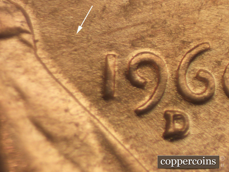 Die-stage B marker on 1960D•1MM•049 showing Long die scratch runs NE-SW from bow-tie to top of 9.