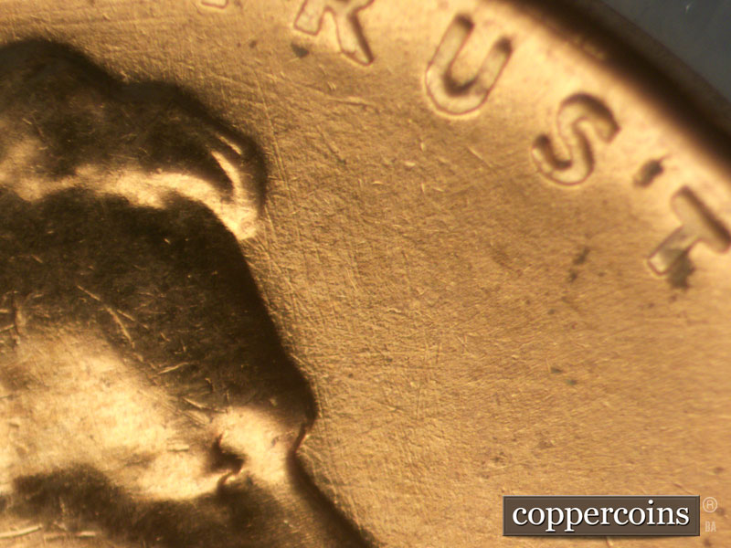Die-stage B marker on 1960D•1MM•050 showing SSE die scratches in front of forehead.